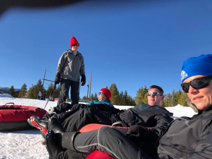 Wes, Alma, Tim, Bonnie and Michael (taking the pic) sitting in rubber tubes getting ready to go down the snow tubing hill