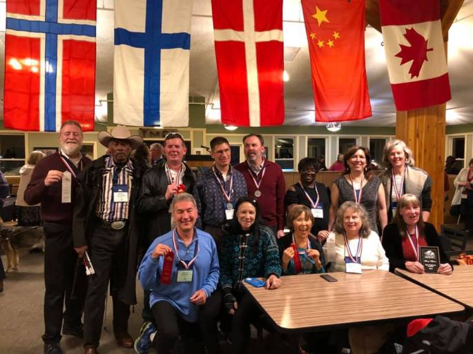 Team Texas after the banquet celebrating their victory holding up all their ribbons and medals