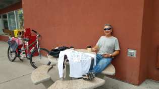 Michael relaxing at an outdoor table at McDonald's and eaning against a wall
